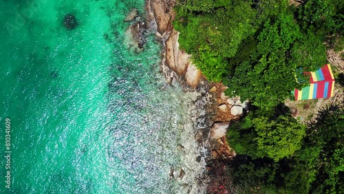 Island Cabins in lush fores, emerald waters bay. Spectacular aerial view drone photo