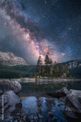 Majestic night scenery with the Milky Way reflected in a mountain lake in the Alps
