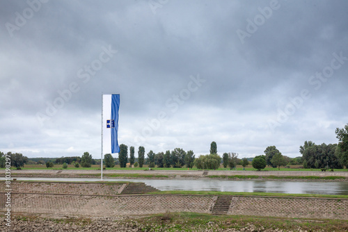 Osijek city flag with the coat of arms of the city in front of Osijek waterfront on drava river It's official visual & symbol of Osijek, one of the main cities of Slavonia, in Croatia, Central Europe. photo