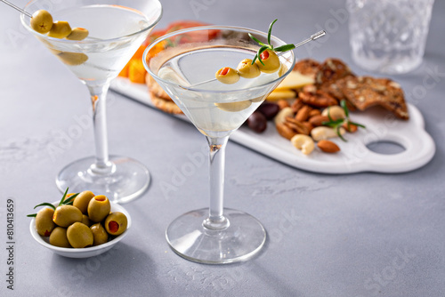 Traditional martini cocktail with olive garnish and charcuterie board photo