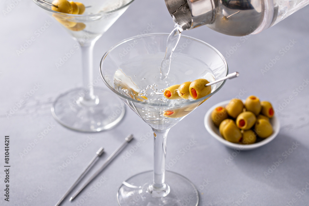 Traditional martini cocktail being poured in a glass Traditional martini cocktail being poured in a glass