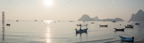Panoramic beautiful sunrise on the ocean.  Boats and tropical sea. Beautiful landscape from the viewpoint at Prachuap Bay in Prachuap Khiri Khan Province, Thailand. © yotrakbutda