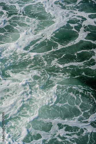 Turbulent ocean water and sea foam
