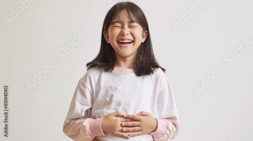 This detailed and realistic image portrays an Asian girl joyfully laughing while holding her tummy, exuding happiness and genuine emotion. Her expressive facial features and body language convey