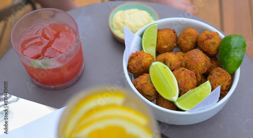 Fototapeta Naklejka Na Ścianę i Meble -  Bolinhos de Bacalhau is a very popular snack or appetizer, with cocktails, whether at a hole in the wall or at a luxury hotel restaurant, Copacabana BR