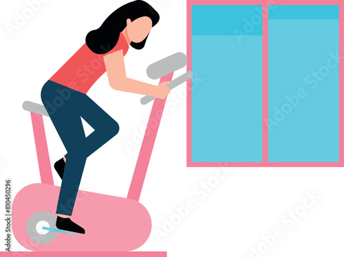 The girl is exercising on the cycling machine.