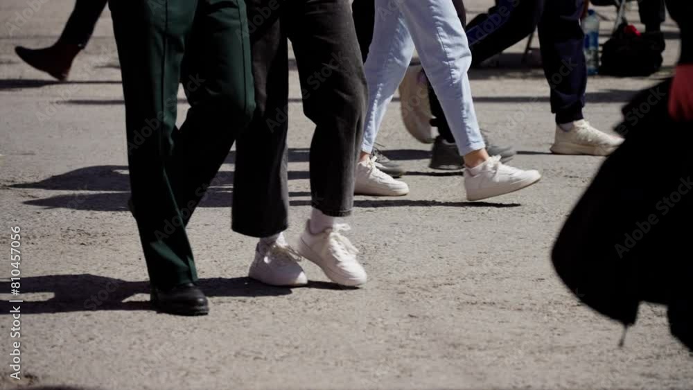 Dynamic low-angle view of diverse feet in motion on a city street, featuring a range of shoes and styles Dynamic low-angle view of diverse feet in motion on a city street, featuring a range of shoes and styles