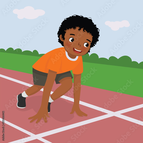 Cute little African boy prepare to run on starting position at race track 