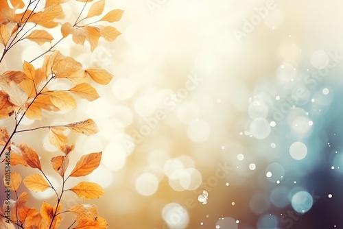 Dry Yellow Leaves and Tree Branches on Blue and Orange Gradient Blur Bokeh Background. Copy Space for Autumn Banner or Poster