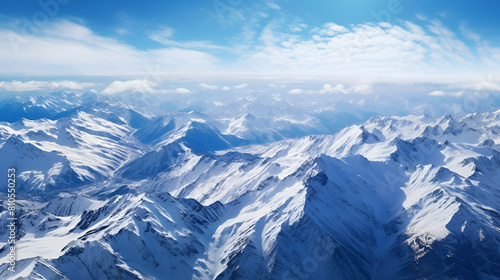 A snowy mountain range with a blue sky and clouds in winter with beautiful background 