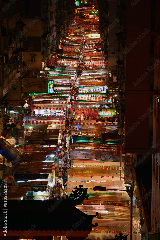 Bird view of Night Market at Temple street full of stalls in Hong Kong at night. Bird view of Night Market at Temple street full of stalls in Hong Kong at night.