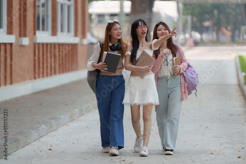 Asian teenage student and friends talking and enjoying at university. back to school concept © Korakot