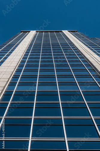 Low view of a facade of an office building with sky.