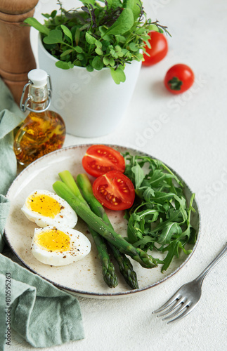 Fresh Spring Salad With Boiled Eggs, Asparagus, and Tomatoes on a Bright Day © Olena Rudo
