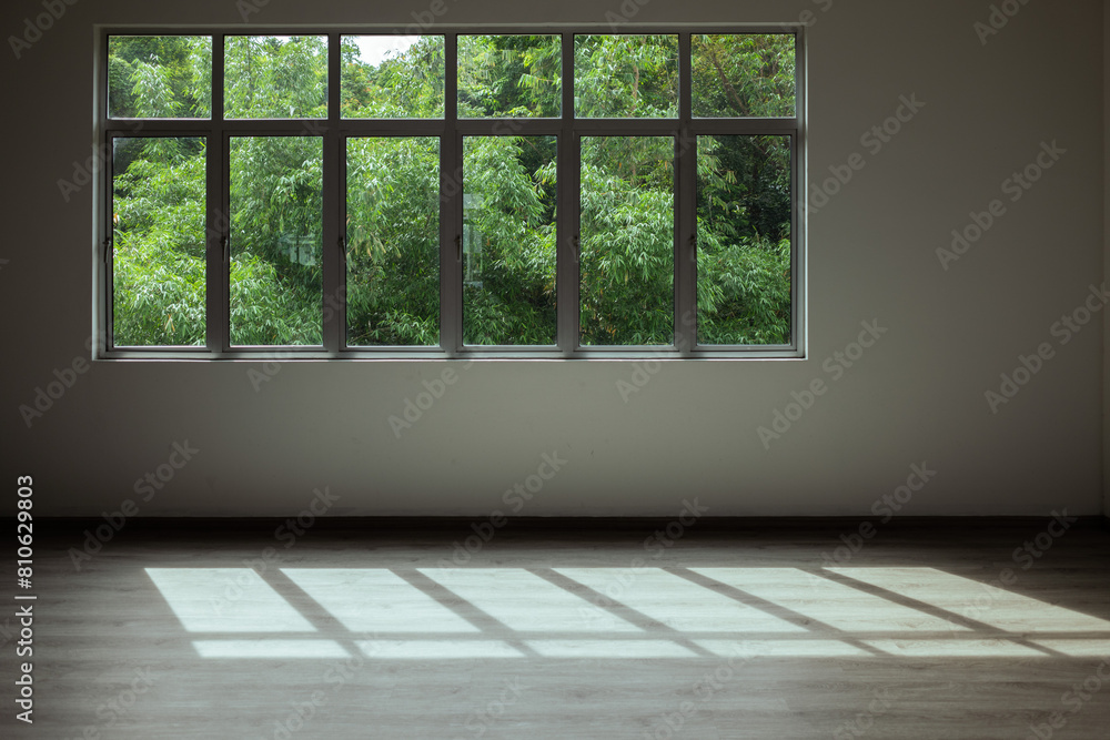 Greenery view through glass windows. Biophilic architecture interior. Residential interior window with sunlight. Greenery view through glass windows. Biophilic architecture interior. Residential interior window with sunlight.