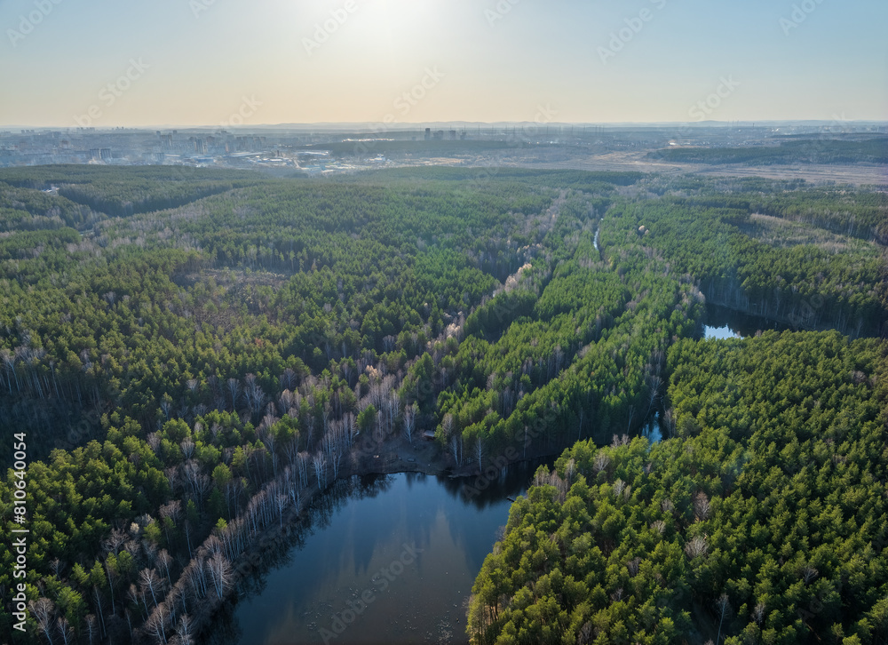 Spring or autumn lake in forest. Aerial view of lake in spring or autumn