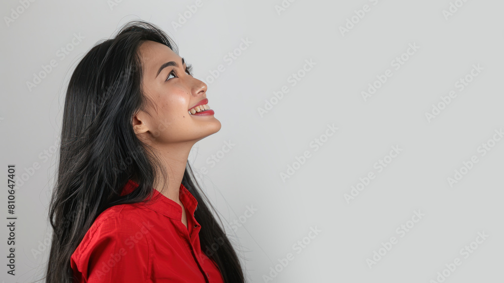 Malay business woman in red shirt smiling looking at the future Malay business woman in red shirt smiling looking at the future