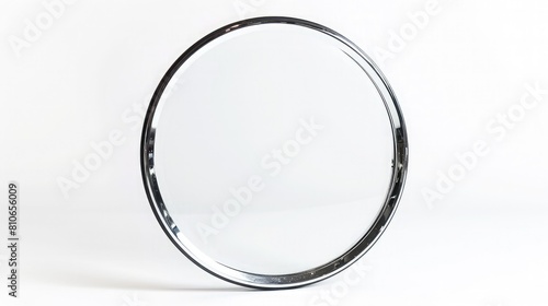 A classic, circular frame with a polished edge, its simplicity highlighting the purity of the white background.