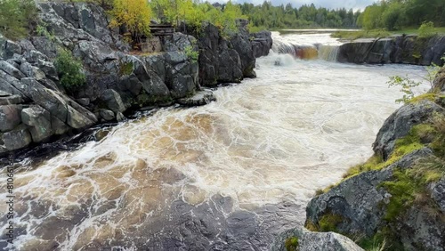 Voytsky padun waterfall in autumn. The famous powerful and wide Karelian waterfall Voytsky Padun is surrounded by rocks and greenery. Cascading waterfall on the river. Karelia, Russia 4K photo