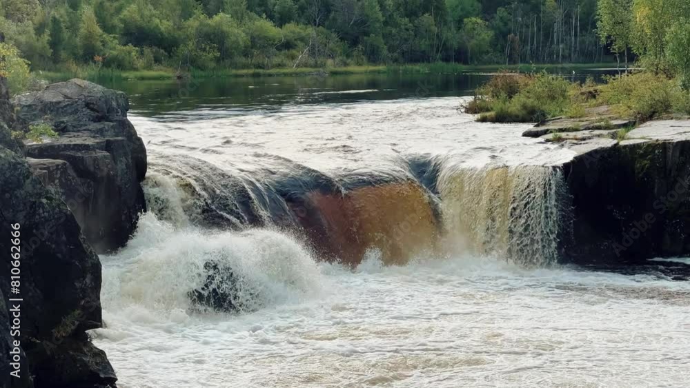 Voytsky padun waterfall in autumn. The famous powerful and wide Karelian waterfall Voytsky Padun is surrounded by rocks and greenery. Cascading waterfall on the river. Karelia, Russia 4K