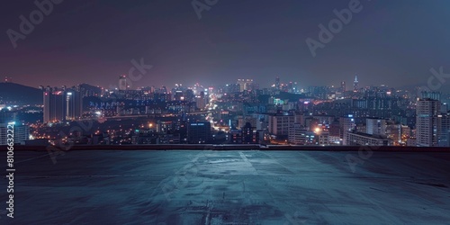 Fototapeta Naklejka Na Ścianę i Meble -  A city skyline at night with a dark sky and a few clouds