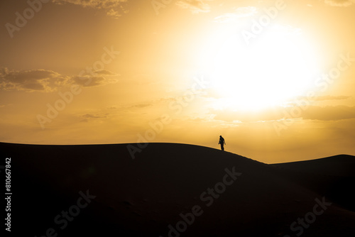 silhouette of a person standing on a hill, Sahara sands, Morocco