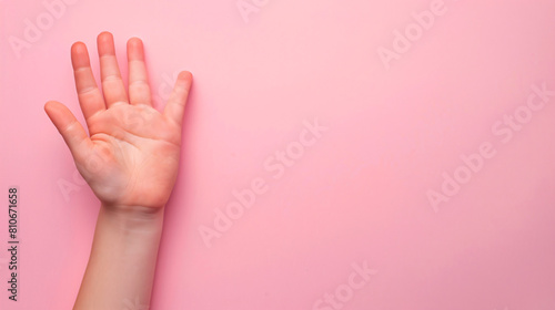 Text WORLD AUTISM AWARENESS DAY and childs hand on pink