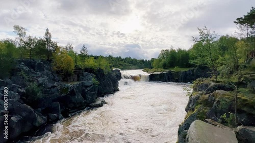 Voytsky padun waterfall in autumn. The famous powerful and wide Karelian waterfall Voytsky Padun is surrounded by rocks and greenery. Cascading waterfall on the river. Karelia, Russia 4K photo