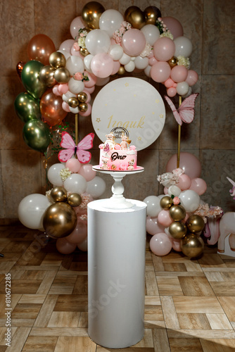 Pink birthday cake with fivot figures and chocolate balls