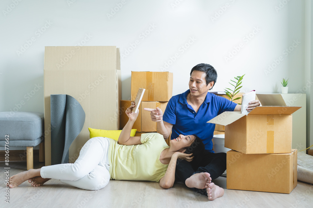 Asian couple lover unpacking thing after relocation to new apartment. Asian couple lover unpacking thing after relocation to new apartment.