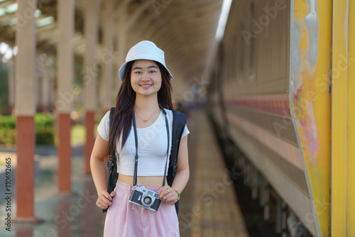 Asia woman travelers feel happiness before going to travel at the train station, Travel, and lifestyle concept.