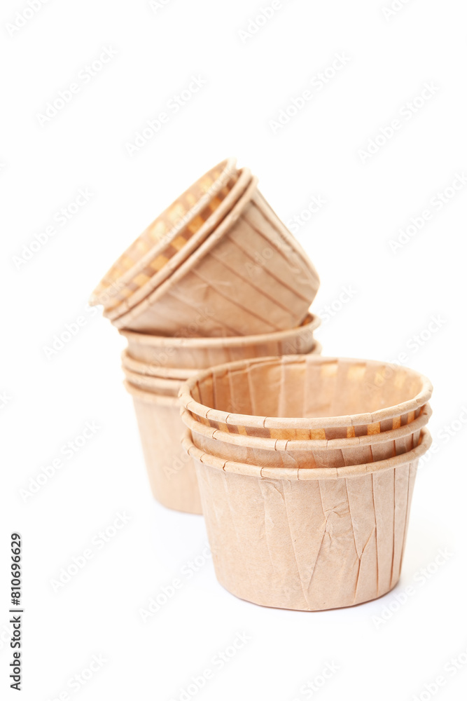 Paper cups for cupcakes or muffins on white background Paper cups for cupcakes or muffins on white background