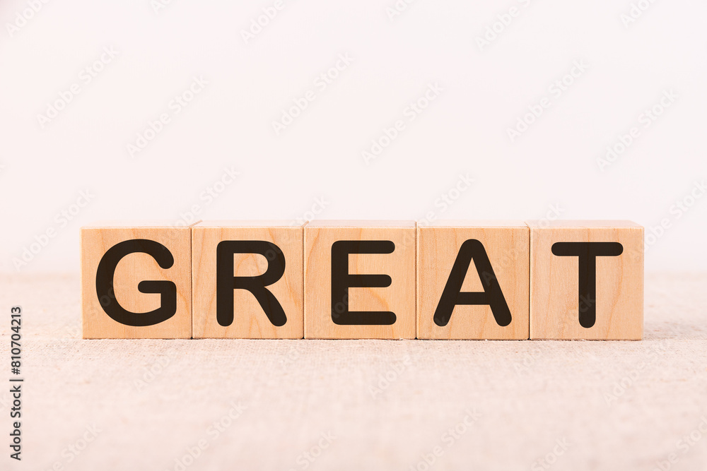 Fototapeta premium GREAT word concept written on a light table and light background
