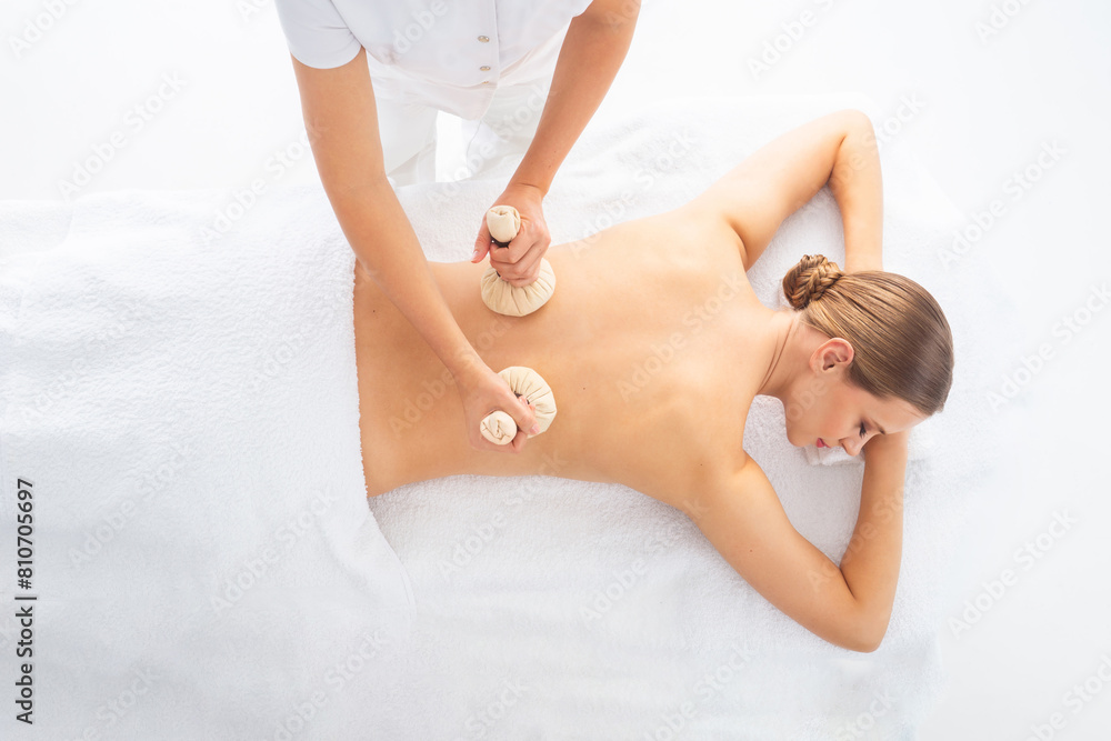 Fototapeta premium Young woman getting massaging treatment over white. Spa, healthcare and recreation concept.