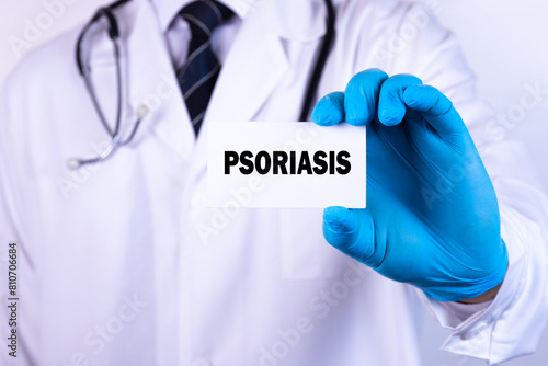 Doctor holding a card with text Psoriasis medical concept photo