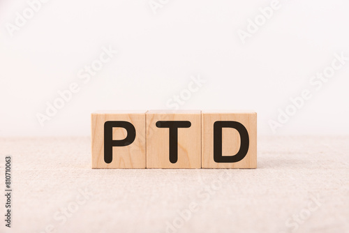 PTD word concept written on a light table and light background photo