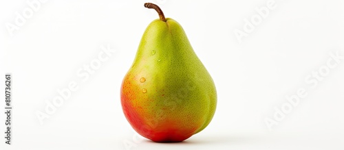 Close up of a pear with green and red tones positioned on a white background providing ample copy space in the image photo