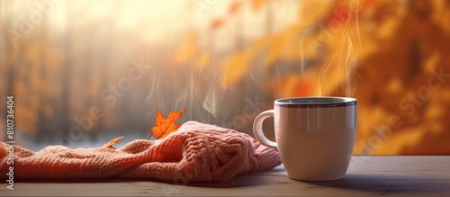 An inviting scene with a hot cup of cozy drink and an autumn sweater placed on a table providing ample space for text in the image