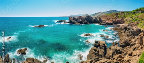 A captivating image showcasing a panoramic view of the turquoise sea meeting the rugged shore providing ample copy space for the perfect visual composition