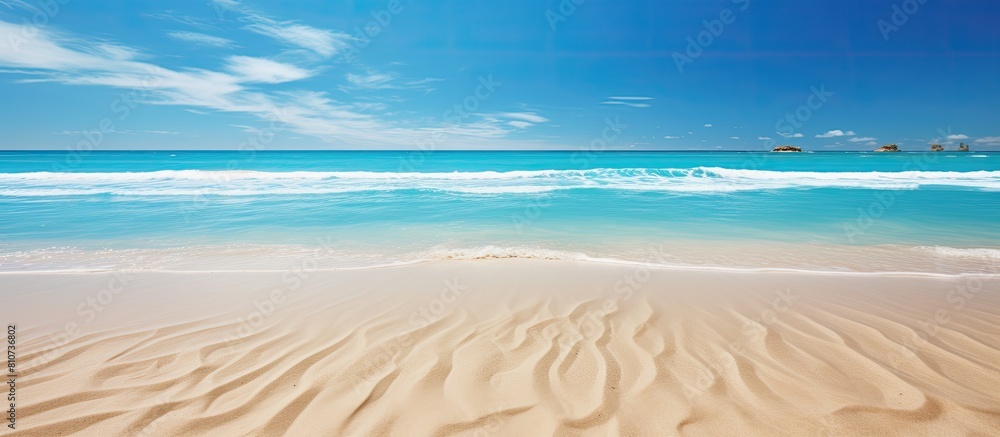A copy space image on a stunning beach showcases the phrase Out of Office written in sand with the mesmerizing backdrop of blue waves portraying a concept of relaxation