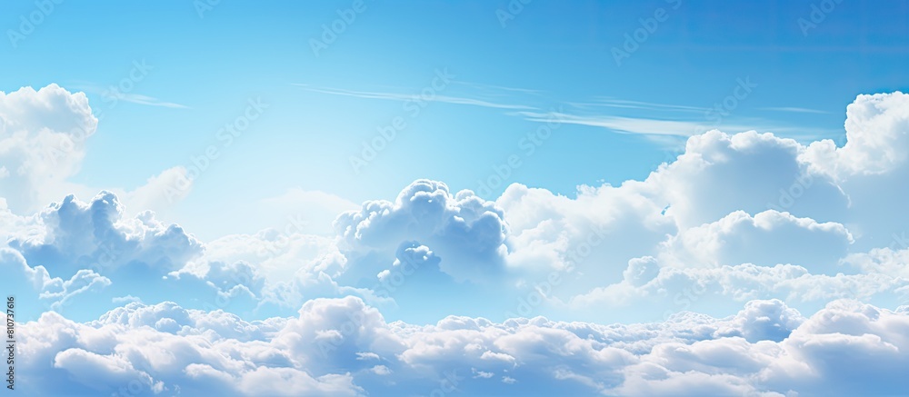A background image showing a spacious expanse of blue sky and fluffy clouds perfect for adding text or other elements. Creative banner. Copyspace image A background image showing a spacious expanse of blue sky and fluffy clouds perfect for adding text or other elements. Creative banner. Copyspace image