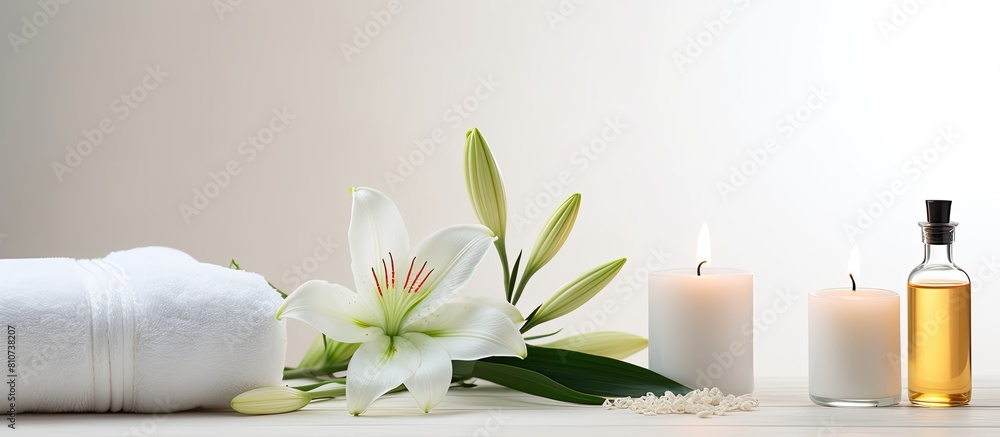 A serene wellness setting showcases a beautiful lily a towel a candle and an oil bottle on a white background providing ample copy space for your own use A serene wellness setting showcases a beautiful lily a towel a candle and an oil bottle on a white background providing ample copy space for your own use