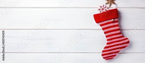 A copy space image of a New Year stocking sock displayed on a white wooden background It s a festive Christmas card perfect for the winter holidays photo