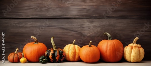 A copy space image of pumpkins sitting on a rustic light wood table