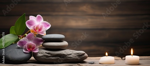 A serene spa inspired composition featuring stones flowers and a flickering candle on a rustic wood backdrop Perfect for a copy space image
