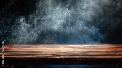 On a black background, an empty wooden table shrouded in smoke. Empty space to showcase your products with smoke on a dark background.