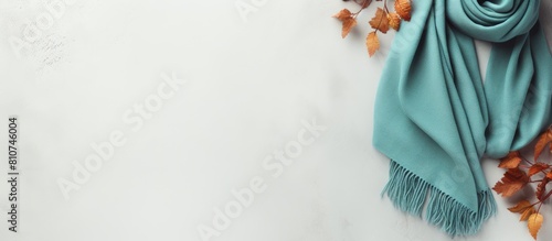 Top view of a cozy autumn flat lay on a white concrete background featuring warm women s clothing in the color of Tiffany including a jacket shoes and scarf with ample copy space for customization photo