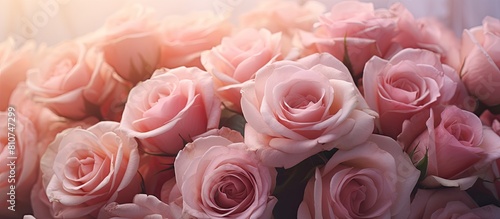 A closeup image of a background with a bouquet of delicate roses provides ample copy space