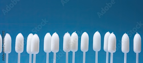 Hygienic cotton swabs for ears positioned on a textured blue backdrop an ideal setting for adding text or copying the image. Creative banner. Copyspace image