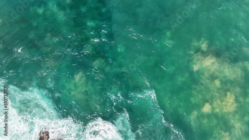 Aerial view of the ocean and clear blue water 